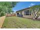 Spacious backyard with lush green grass, wooden fencing, and an external air conditioning unit at 1216 Fox Chapel Dr, Lutz, FL 33549