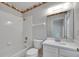 Classic bathroom featuring a shower-tub combo, vanity with sink, and decorative wallpaper border at 1216 Fox Chapel Dr, Lutz, FL 33549