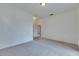 Bedroom with neutral carpet and doorway providing access to other rooms at 1216 Fox Chapel Dr, Lutz, FL 33549