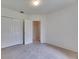 Bright bedroom featuring soft carpet and closet with bifold doors, next to a door at 1216 Fox Chapel Dr, Lutz, FL 33549