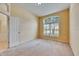 Comfortable bedroom with an arched window, providing ample natural light and a view of the outdoors at 1216 Fox Chapel Dr, Lutz, FL 33549
