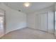 Bright bedroom featuring neutral carpet, closet, and ample natural light at 1216 Fox Chapel Dr, Lutz, FL 33549