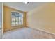 Cozy bedroom features a large arched window with shutter blinds, allowing for plenty of natural light at 1216 Fox Chapel Dr, Lutz, FL 33549