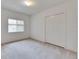Bedroom with neutral carpet, closet, and a window providing natural light at 1216 Fox Chapel Dr, Lutz, FL 33549
