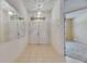 Bright foyer with tile flooring, a view into an adjacent living space and a double door entry at 1216 Fox Chapel Dr, Lutz, FL 33549