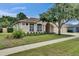 Beautiful single-Gathering home featuring a well-manicured lawn and a spacious three-car garage at 1216 Fox Chapel Dr, Lutz, FL 33549