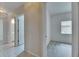 Open hallway leads to a carpeted bedroom with a window and a bathroom with tile flooring at 1216 Fox Chapel Dr, Lutz, FL 33549