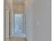 Bright hallway featuring neutral paint and carpet, with open doorways offering views into other rooms at 1216 Fox Chapel Dr, Lutz, FL 33549
