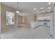Well-lit kitchen featuring white appliances and open access to the living room at 1216 Fox Chapel Dr, Lutz, FL 33549
