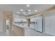 Bright, tiled kitchen featuring white appliances and adjacent breakfast bar at 1216 Fox Chapel Dr, Lutz, FL 33549