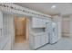 Bright kitchen with white cabinets and appliances, offering a practical and efficient space at 1216 Fox Chapel Dr, Lutz, FL 33549