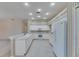 Bright kitchen featuring white appliances, breakfast bar, and tile flooring at 1216 Fox Chapel Dr, Lutz, FL 33549