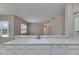 Bright kitchen with a large sink, white cabinets and appliances with an open view into the home at 1216 Fox Chapel Dr, Lutz, FL 33549