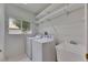 Well-lit laundry room with appliances, sink and shelves at 1216 Fox Chapel Dr, Lutz, FL 33549