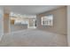 Open living room with carpet and tile, flowing to kitchen, creating a welcoming and connected living space at 1216 Fox Chapel Dr, Lutz, FL 33549