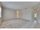Spacious living room featuring tile and carpet flooring with natural light and entry access at 1216 Fox Chapel Dr, Lutz, FL 33549