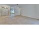 Spacious living room with tiled entry and view to bedroom, offering an open layout and natural light at 1216 Fox Chapel Dr, Lutz, FL 33549
