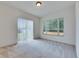 A sunlit living room with neutral carpet and multiple windows providing views to the outdoors at 1216 Fox Chapel Dr, Lutz, FL 33549