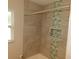 Stylish bathroom with tiled shower, a built-in niche, and modern fixtures at 12417 N Rome Ave, Tampa, FL 33612