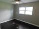 Comfortable bedroom with ceiling fan, one window, and hardwood floors at 12417 N Rome Ave, Tampa, FL 33612