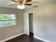 Well-lit bedroom features a closet, ceiling fan, and a window providing natural light at 12417 N Rome Ave, Tampa, FL 33612