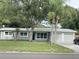 Charming single-story home with a well-maintained lawn and mature trees in a desirable neighborhood at 12417 N Rome Ave, Tampa, FL 33612