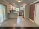 Bright kitchen featuring white cabinetry, stainless steel appliances, a breakfast bar, and tile flooring at 12417 N Rome Ave, Tampa, FL 33612