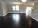 Spacious living room with dark hardwood floors and abundant natural light from a sliding glass door at 12417 N Rome Ave, Tampa, FL 33612