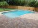 Private backyard pool with brick paver deck, ladder and privacy fence at 12417 N Rome Ave, Tampa, FL 33612
