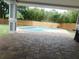 Covered outdoor patio with a brick-paved deck leading to a refreshing private pool and fenced-in yard at 12417 N Rome Ave, Tampa, FL 33612