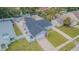 Fenced single-story home with gravel landscaping, a large backyard, lush trees, and a long driveway at 13916 Briardale Ln, Tampa, FL 33618