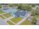 A single-story home features a big backyard, long driveway, lush landscaping, and a neutral color palette at 13916 Briardale Ln, Tampa, FL 33618