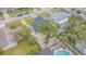 An overhead view of a single-Gathering home showcasing a backyard pool, mature trees, and a well-maintained landscape at 13916 Briardale Ln, Tampa, FL 33618
