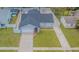 Single-story home with a two-car garage, neutral color scheme, fenced yard, and gravel landscaping at 13916 Briardale Ln, Tampa, FL 33618