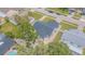 Single-story house with a fenced backyard, large tree, gravel landscaping, and nearby neighborhood amenities at 13916 Briardale Ln, Tampa, FL 33618