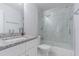 Modern bathroom with marble countertops, a glass-enclosed shower, and sleek white cabinetry at 13916 Briardale Ln, Tampa, FL 33618