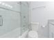 Clean bathroom with glass shower door, white tiling, and modern fixtures at 13916 Briardale Ln, Tampa, FL 33618