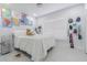 Cozy bedroom with white walls, a comfortable bed, and world map posters at 13916 Briardale Ln, Tampa, FL 33618