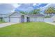 Charming single-story home featuring a well-manicured lawn, tidy landscaping, and attached two-car garage at 13916 Briardale Ln, Tampa, FL 33618