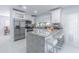 A kitchen showcasing granite counters, white cabinets, stainless steel appliances, and a cozy breakfast bar at 13916 Briardale Ln, Tampa, FL 33618