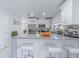 Bright, modern kitchen with granite countertops, stainless appliances, and stylish bar seating at 13916 Briardale Ln, Tampa, FL 33618