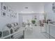Bright living room with modern decor, neutral colors, and a gallery wall of framed photographs at 13916 Briardale Ln, Tampa, FL 33618