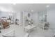 Spacious living room with white flooring, modern furnishings, and multiple seating areas at 13916 Briardale Ln, Tampa, FL 33618