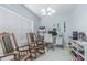 Well-lit office with two rocking chairs and a modern desk setup at 13916 Briardale Ln, Tampa, FL 33618