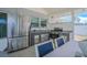 This outdoor kitchen boasts stainless steel appliances and a granite countertop with space for seating at 13916 Briardale Ln, Tampa, FL 33618