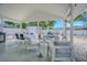 Covered patio with comfortable seating, a dining area, and a serene outdoor living space at 13916 Briardale Ln, Tampa, FL 33618