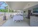 Outdoor patio features dining area, a full stainless kitchen, and stylish seating for relaxation and entertainment at 13916 Briardale Ln, Tampa, FL 33618