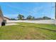 Spacious backyard featuring a well-kept lawn, privacy fence, and a small concrete patio for outdoor enjoyment at 15442 Arvin Dr, Brooksville, FL 34604