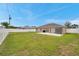 Large backyard featuring a green lawn, privacy fence, and a concrete patio area, perfect for outdoor activities at 15442 Arvin Dr, Brooksville, FL 34604