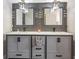 Stylish bathroom with dual sinks, modern lighting, and sleek cabinetry at 15442 Arvin Dr, Brooksville, FL 34604